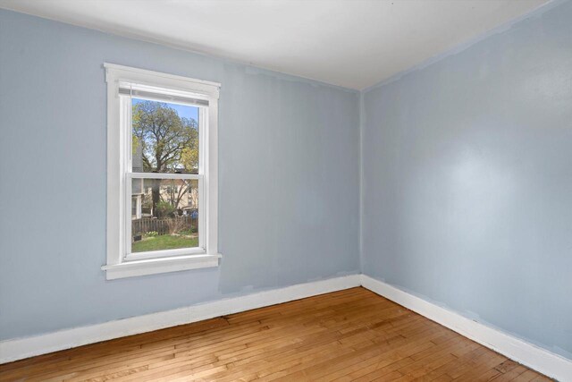 3303 W Juneau Ave Unit 3311, Milwaukee, WI 53208 - empty room with hardwood / wood-style flooring and baseboards