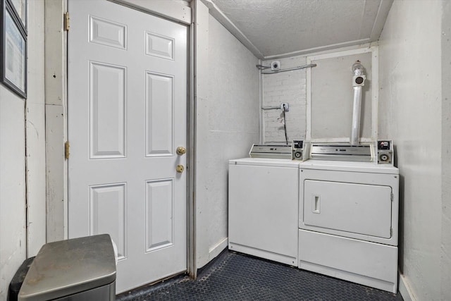 3303 W Juneau Ave Unit 3311, Milwaukee, WI 53208 - washroom featuring washer and dryer, laundry area, dark tile patterned floors, and a textured ceiling
