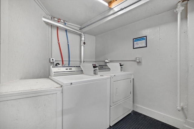 3303 W Juneau Ave Unit 3311, Milwaukee, WI 53208 - common laundry area featuring washing machine and dryer and dark tile patterned flooring