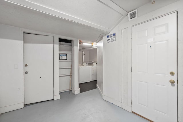3303 W Juneau Ave Unit 3311, Milwaukee, WI 53208 - interior space featuring ensuite bath, washer and dryer, visible vents, finished concrete floors, and vaulted ceiling