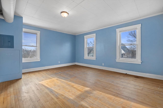 3303 W Juneau Ave Unit 3311, Milwaukee, WI 53208 - unfurnished room featuring electric panel, ornamental molding, baseboards, and wood-type flooring