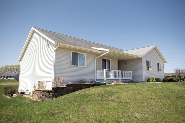 416 Gannon Ct, Tomah, WI 54660 - exterior space featuring covered porch, a shingled roof, and a front yard