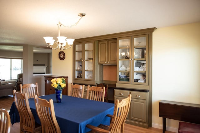 416 Gannon Ct, Tomah, WI 54660 - dining room with a chandelier, baseboards, and light wood finished floors