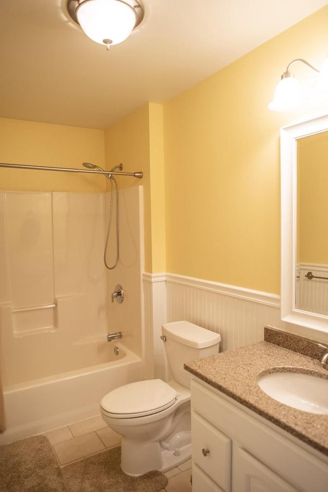 416 Gannon Ct, Tomah, WI 54660 - bathroom featuring toilet, tile patterned floors, vanity, and a wainscoted wall