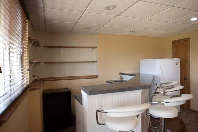416 Gannon Ct, Tomah, WI 54660 - interior space with freestanding refrigerator and a drop ceiling
