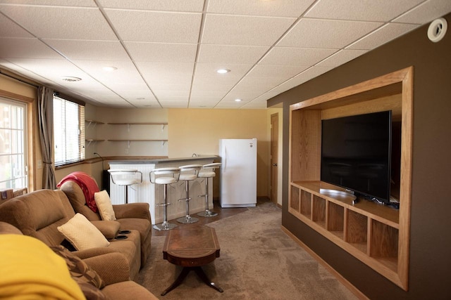 416 Gannon Ct, Tomah, WI 54660 - carpeted living room with bar, a drop ceiling, baseboards, and recessed lighting
