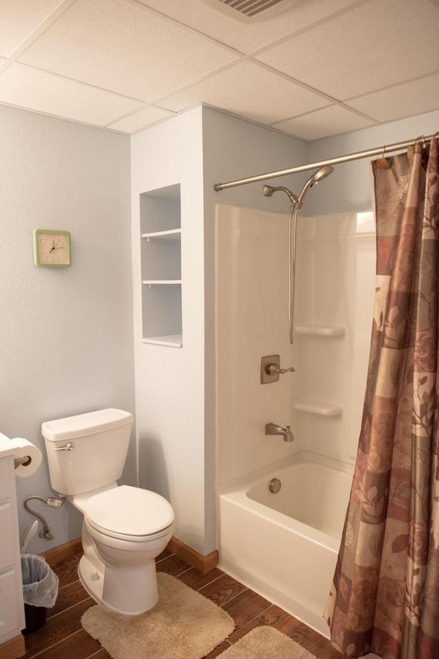 416 Gannon Ct, Tomah, WI 54660 - full bathroom featuring a drop ceiling, toilet, shower / tub combo, and wood finished floors