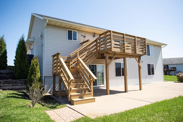 416 Gannon Ct, Tomah, WI 54660 - back of property with stairway, a deck, and a patio area