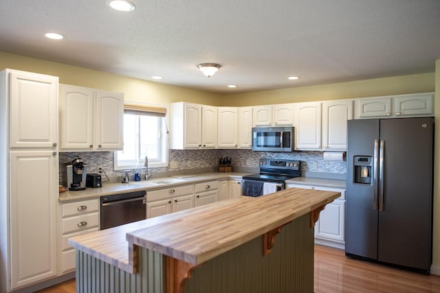 416 Gannon Ct, Tomah, WI 54660 - kitchen featuring light wood finished floors, butcher block counters, appliances with stainless steel finishes, and a sink