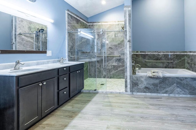 bathroom with a sink, lofted ceiling, a garden tub, and a shower stall