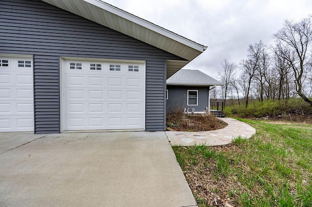 view of property exterior with concrete driveway and a garage