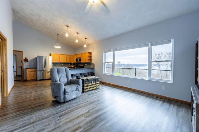 living room featuring high vaulted ceiling, visible vents, dark wood-style flooring, ceiling fan, and baseboards