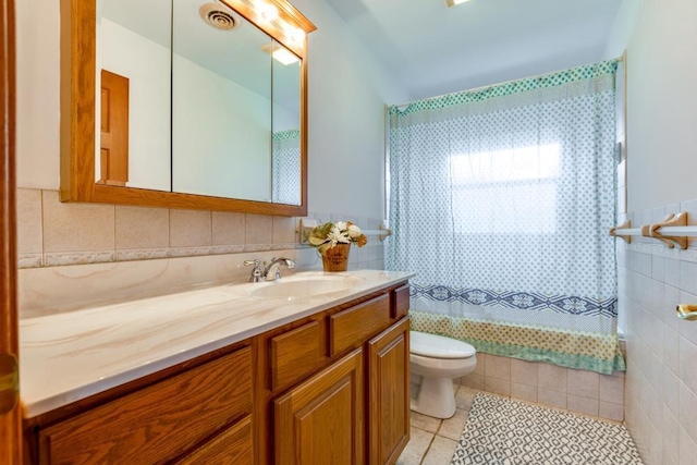 W10940 W Harmony Dr, Lodi, WI 53555 - bathroom featuring tile walls, tile patterned flooring, vanity, and toilet