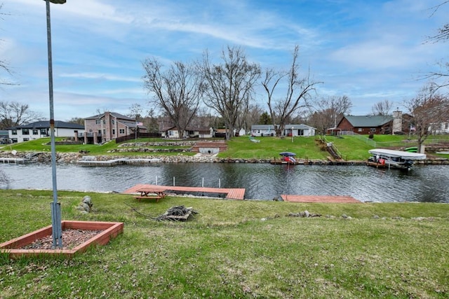 W10940 W Harmony Dr, Lodi, WI 53555 - view of green lawn featuring a dock, a water view, and a residential view