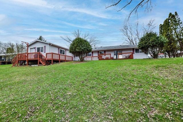 W10940 W Harmony Dr, Lodi, WI 53555 - back of house featuring a wooden deck and a lawn