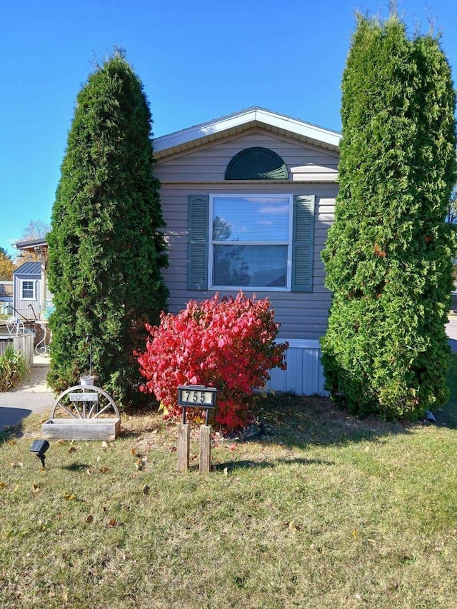 view of side of home featuring a yard