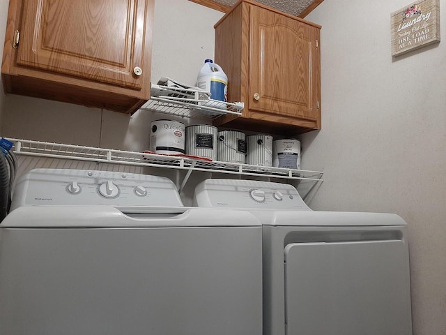 laundry room with cabinet space and washing machine and clothes dryer