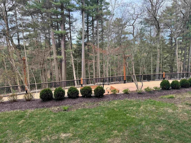 view of yard with fence and a view of trees