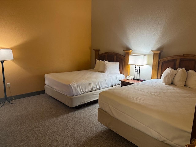 bedroom with baseboards and carpet flooring