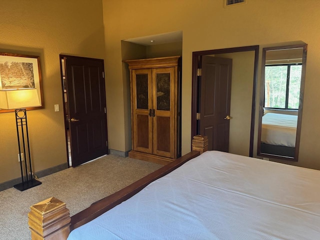 carpeted bedroom featuring baseboards and visible vents