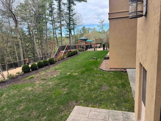 view of yard with stairway, fence, and a playground