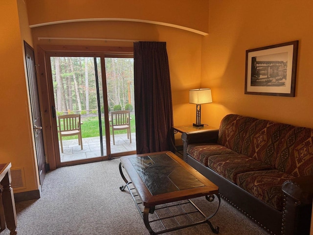 carpeted living room featuring visible vents