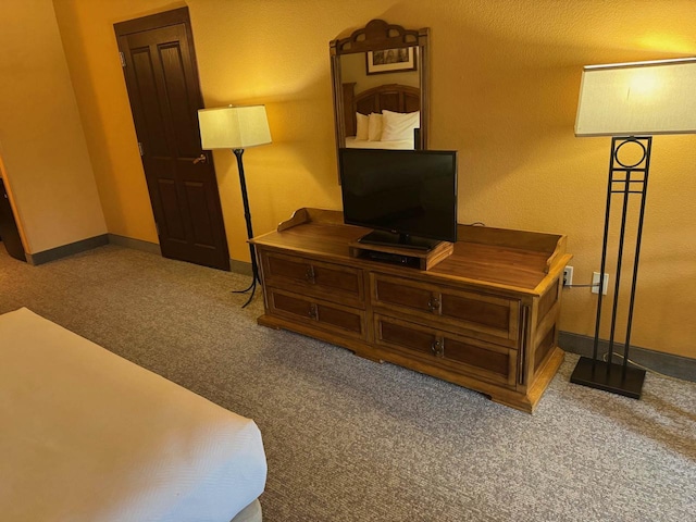 carpeted bedroom featuring baseboards