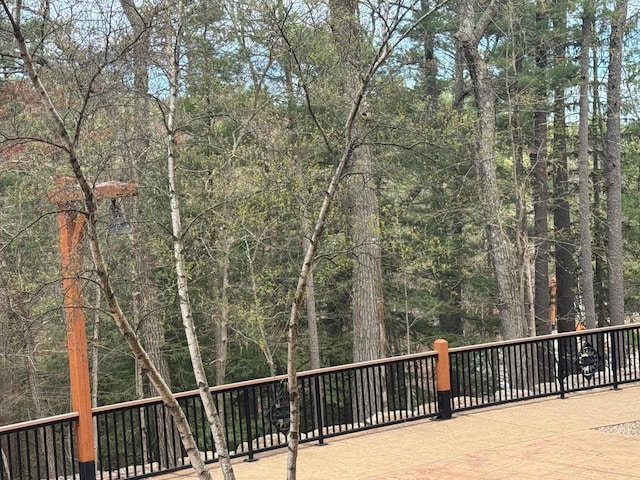 wooden terrace with a view of trees