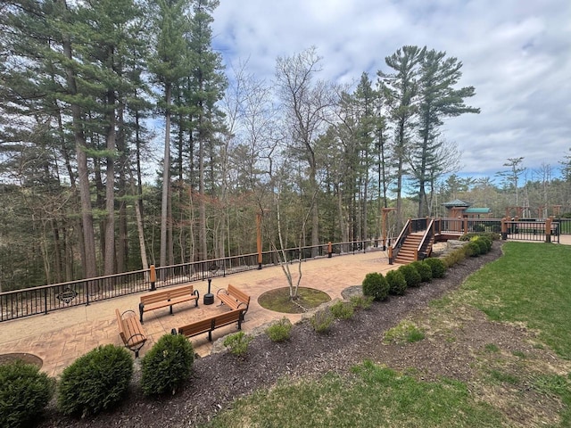 view of property's community with a playground and fence