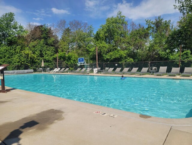 pool featuring a patio and fence