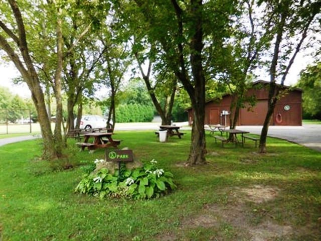 surrounding community featuring a yard, driveway, and a garage
