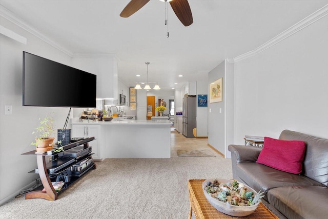 living room featuring light colored carpet, ornamental molding, and a ceiling fan
