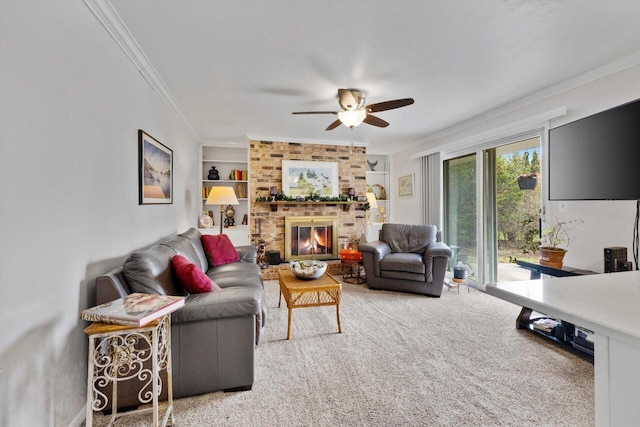 carpeted living area with a fireplace, ceiling fan, ornamental molding, and built in shelves