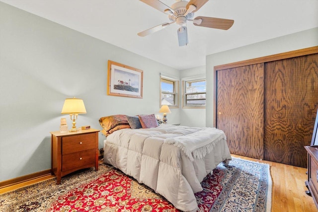 bedroom featuring light wood-style flooring, a closet, and a ceiling fan