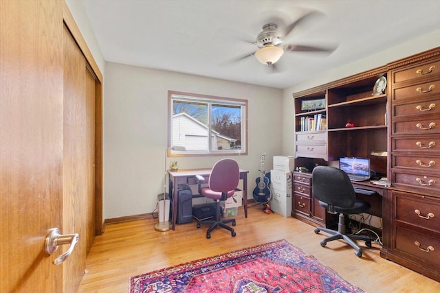 office area with light wood-style flooring and ceiling fan