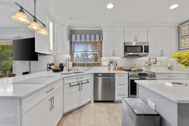 kitchen featuring a sink, white cabinets, crown molding, appliances with stainless steel finishes, and recessed lighting