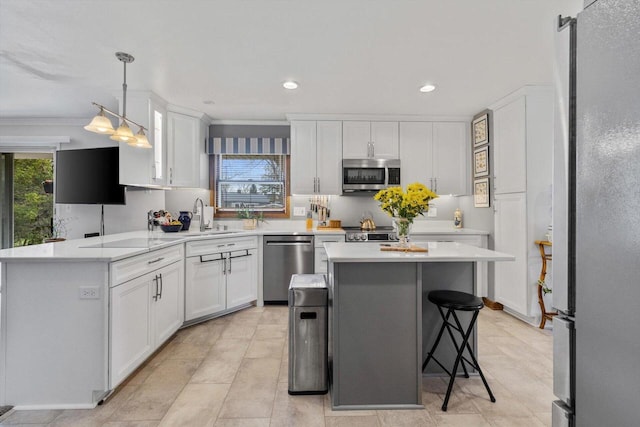 kitchen featuring a sink, stainless steel appliances, a kitchen breakfast bar, white cabinetry, and light countertops
