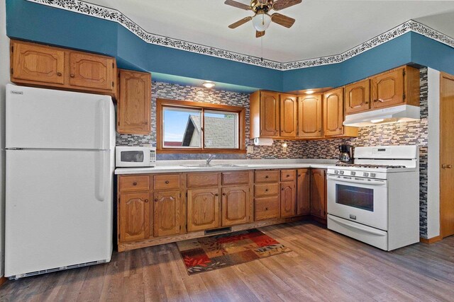 W444 Carlson Ln, Oconto Falls, WI 54154 - kitchen featuring white appliances, under cabinet range hood, a sink, ceiling fan, and dark wood-style flooring