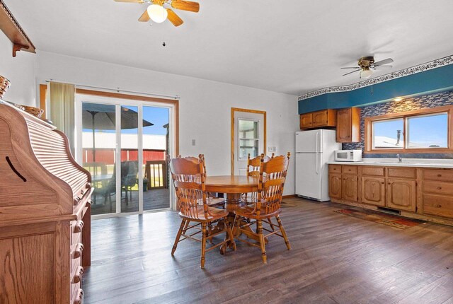 W444 Carlson Ln, Oconto Falls, WI 54154 - dining area featuring ceiling fan, dark wood-style flooring, and healthy amount of natural light