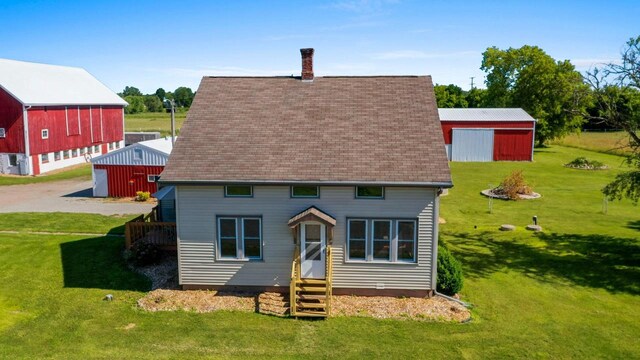 W444 Carlson Ln, Oconto Falls, WI 54154 - rear view of house featuring a chimney, a yard, an outdoor structure, and roof with shingles
