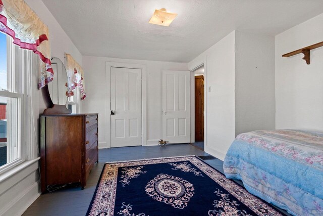W444 Carlson Ln, Oconto Falls, WI 54154 - bedroom featuring wood finished floors, multiple windows, and baseboards