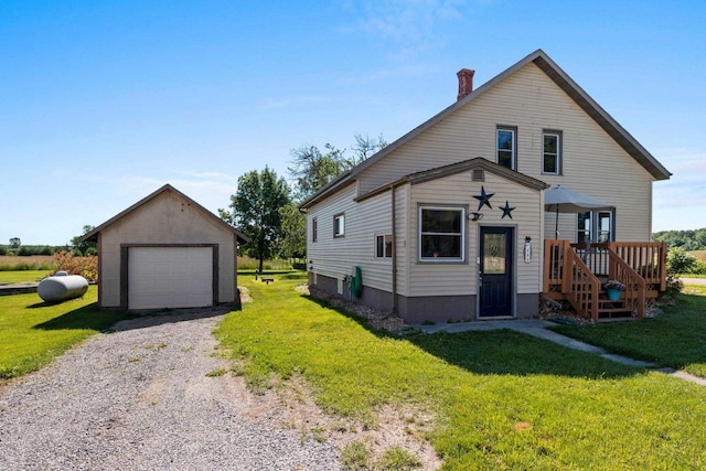 W444 Carlson Ln, Oconto Falls, WI 54154 - view of front of home featuring a garage, a front lawn, an outbuilding, and driveway