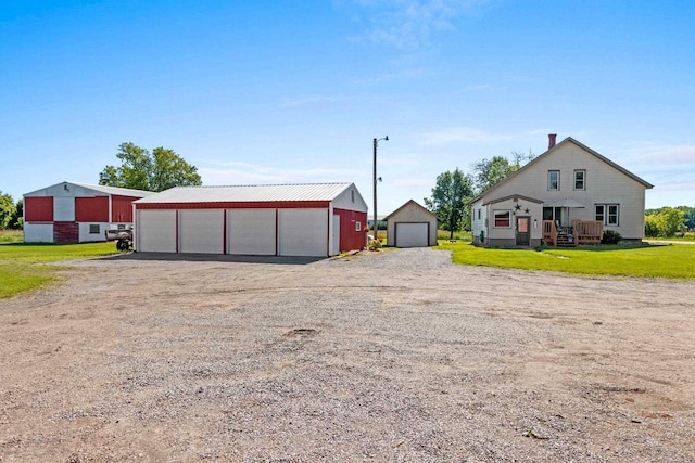 W444 Carlson Ln, Oconto Falls, WI 54154 - view of green lawn with a detached garage, an outdoor structure, and driveway