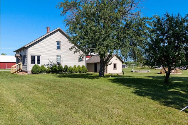 W444 Carlson Ln, Oconto Falls, WI 54154 - back of house with entry steps, a lawn, and a chimney