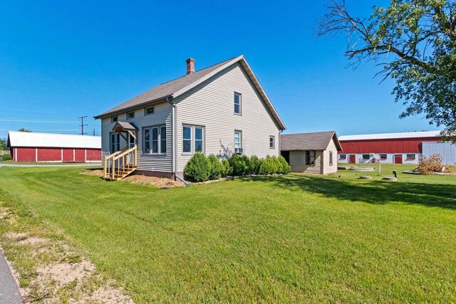 W444 Carlson Ln, Oconto Falls, WI 54154 - rear view of property with a chimney, a lawn, entry steps, and roof with shingles