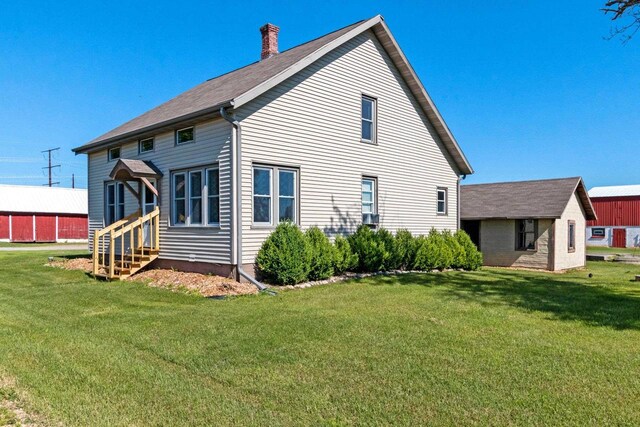 W444 Carlson Ln, Oconto Falls, WI 54154 - back of property with entry steps, a lawn, and a chimney