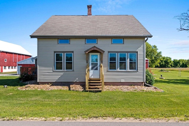 W444 Carlson Ln, Oconto Falls, WI 54154 - view of front of property with entry steps, a chimney, a front yard, and roof with shingles