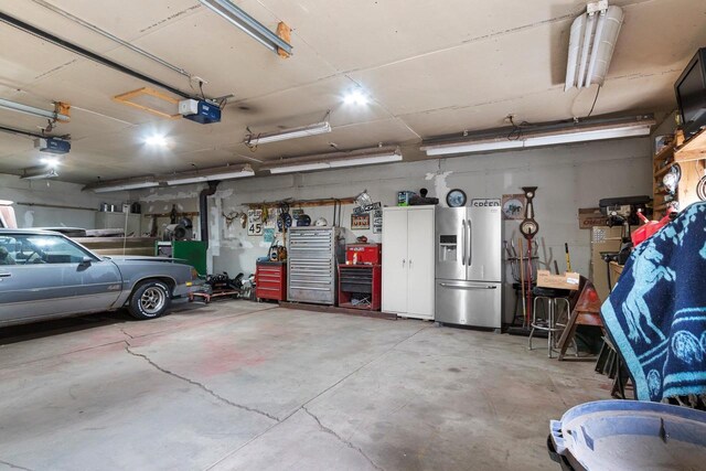 W444 Carlson Ln, Oconto Falls, WI 54154 - garage with stainless steel fridge and a garage door opener