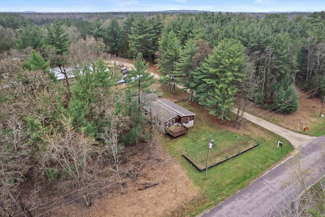 drone / aerial view featuring a wooded view