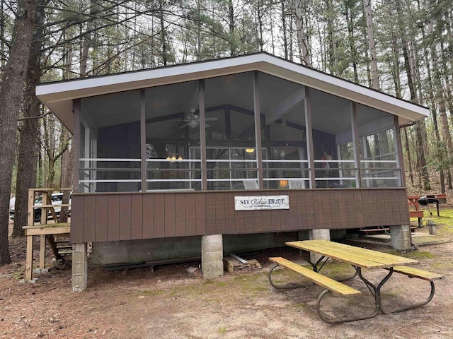 rear view of property featuring a sunroom